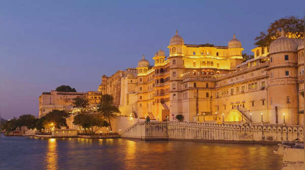 Cityscape featuring a stunning palace on a lake.