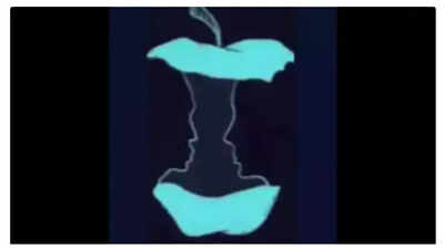 Optical illusion featuring an apple and two faces.