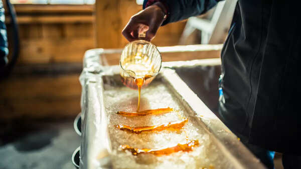 Pouring syrup into a pancake